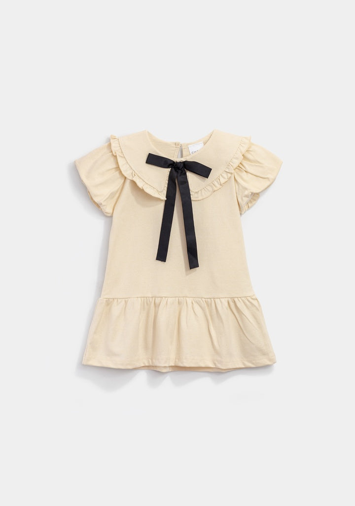 vestido beige moño negro